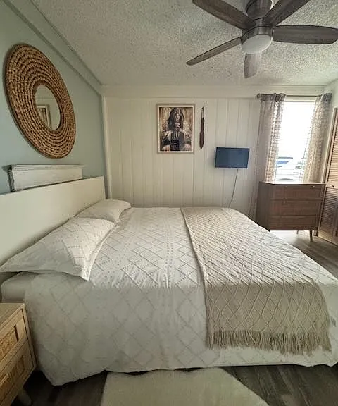Primary bedroom furnished with queen bed, tv and more.
