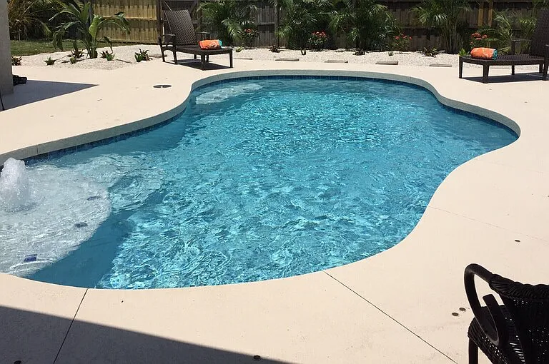 Lanai pool area with lush palm trees, tropical setting in back plenty of space for entertaining or grilling. Heated pool with LED color changing light and privacy from neighbors.