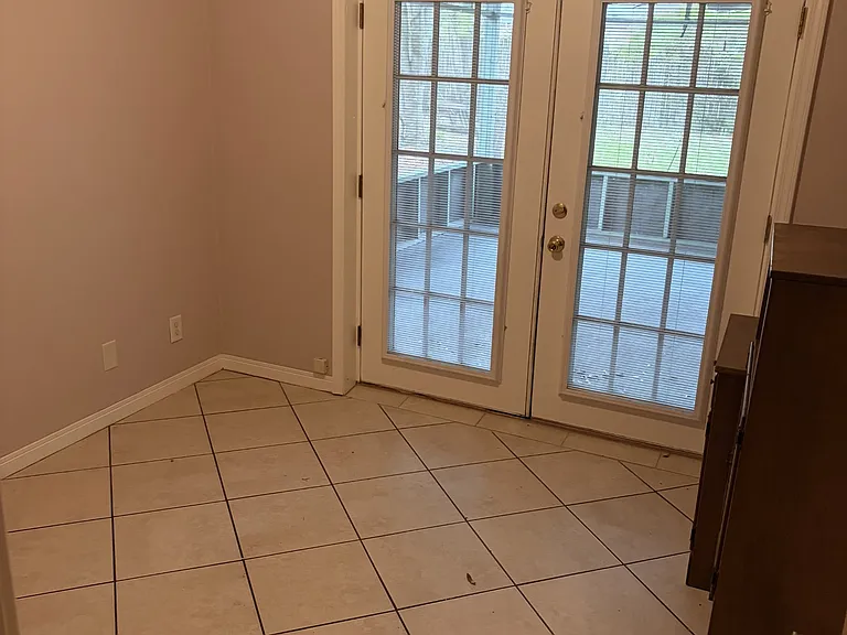 bedroom 2 opens to a screened in porch where washer and dryer are located
