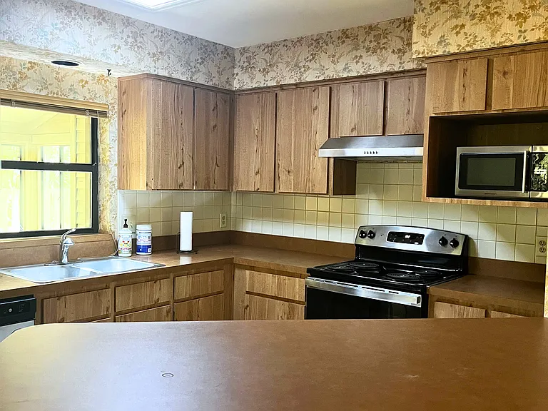 Kitchen has skylight and window