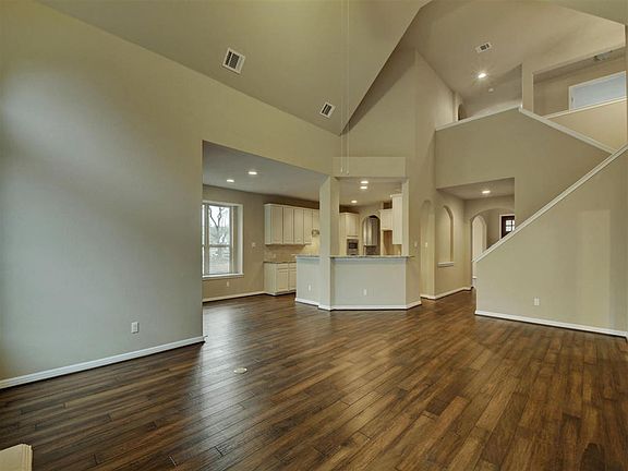 Family room view of kitchen and stairway