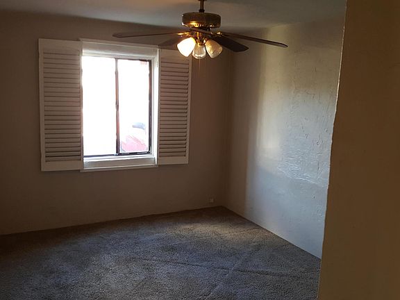 Bedroom #1 with ceiling fan and plantation shutters