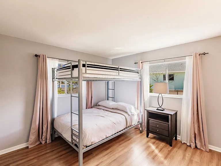 Queen bunks and plenty of light for guests or work space.