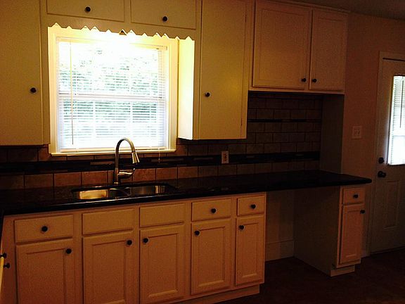 View of the remodeled kitchen with new granite counter top and travertine/glass back splash. New kit