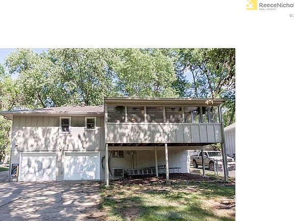 Rear view, 2 car garage and screened in porch