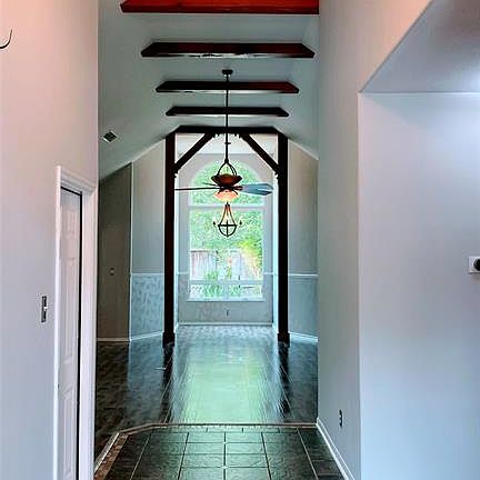 Another New picture from foyer to back; again the new paint shows off the beauty of the high ceilings and custom beams.