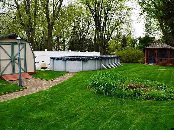 Beautifully landscaped yard w/pool,gazebo,shed and vinyl fence Wow!