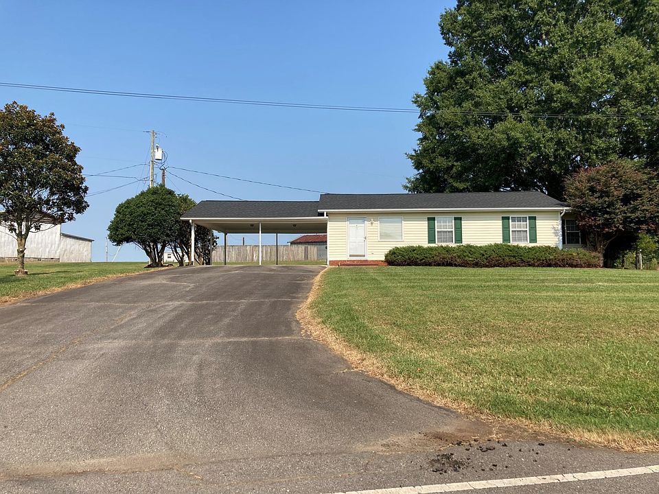 Front of home and 2 car carport