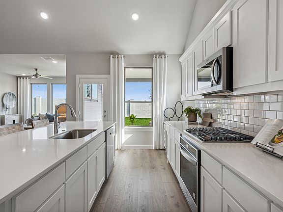 Kitchen in the Wimbledon home plan by Trophy Signature Homes - REPRESENTATIVE PHOTO