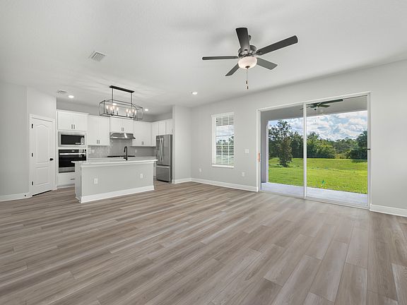 The spacious family room with a sliding door to the back patio