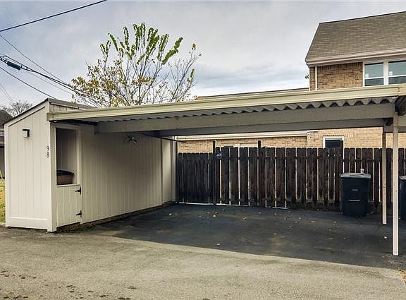 Spacious 2 car carport with storage room and trash cubby! You also have a priv