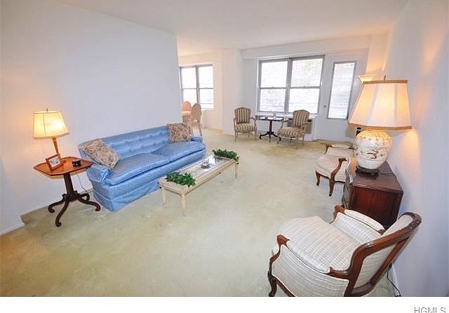 Large sunny living room opens to the "L" shaped dining room and has a door leading to the private Balcony .  The living room also opens to the entry foyer that can be used as a home office area or dining area.  The living room has covered parquet floors a