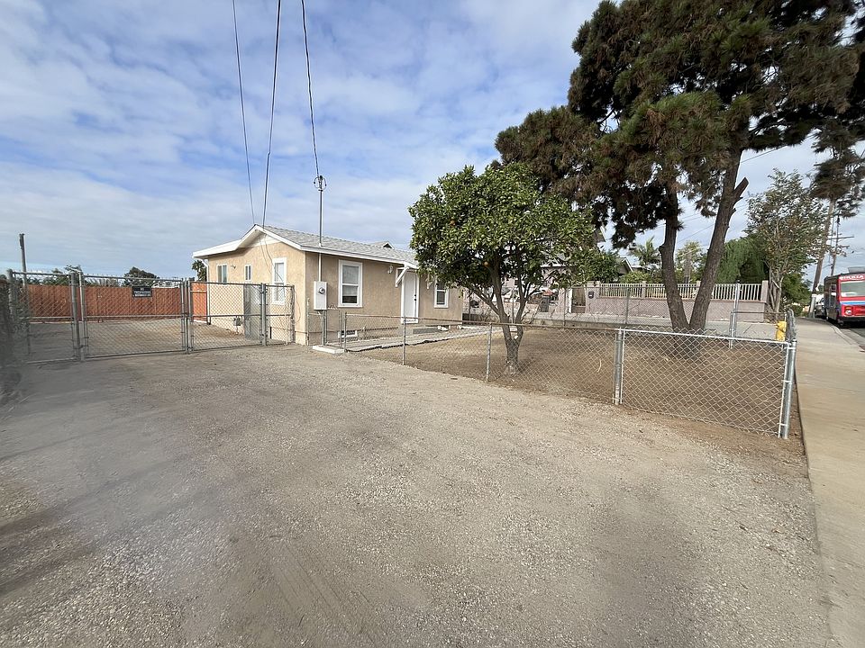 Front of property. Includes front yard with fruit trees, main driveway, view of brand new fence