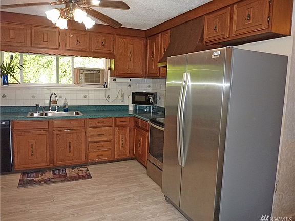 Large open kitchen with newer SS refrigerator
