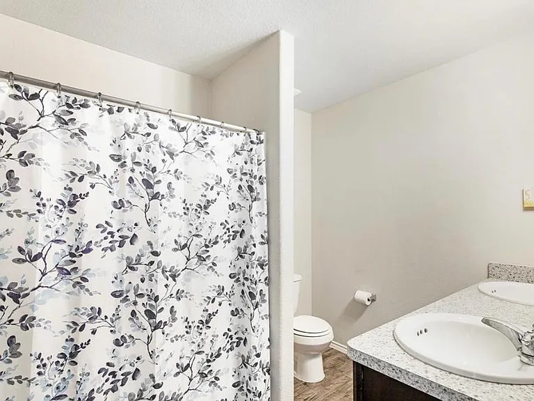 THE UPSTAIRS BATHROOM (TWO SINKS!) ADJACENT TO THE MEDIA ROOM