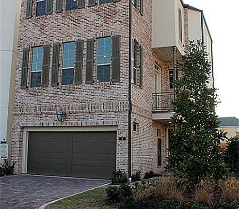 Brick and stucco exterior with beautiful corner lot.