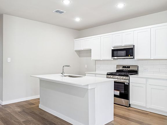 Kitchen in the Willow home plan by Trophy Signature Homes - REPRESENTATIVE PHOTO
