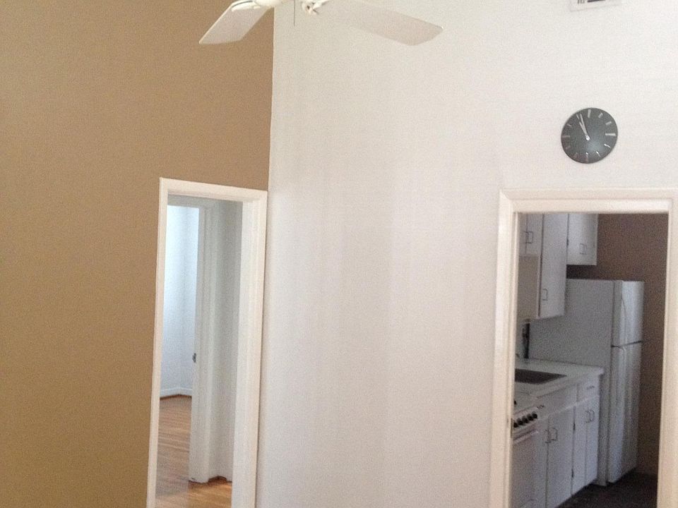 Living area toward kitchen and entry door