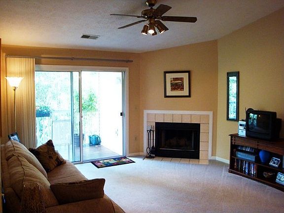 Vaulted ceiling in living room, wood-burning fireplace and private balcony