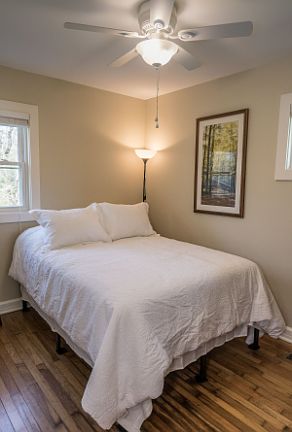 Cozy, well-kept bedroom with hardwood floors, soft natural light, and a clean, comfortable setup_perfect for relocation clients, traveling professionals, or month-to-month renters seeking a peaceful place to recharge.