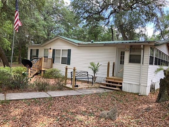 Handrail on both house entrances. Primary door leads to home Living room and secondary entrance leads to Enclosed Sun Room.