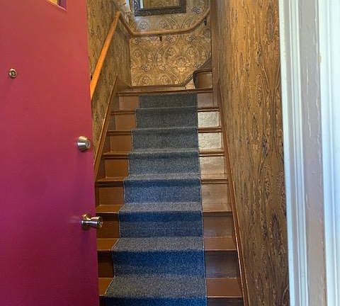 Private Entry to upstairs apartment. Hand railing and wallpaper entrance.