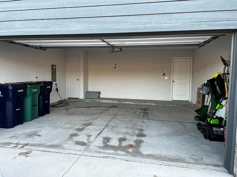 Spacious 2-car garage equipped with a convenient EV charger_perfect for modern, eco-conscious living.