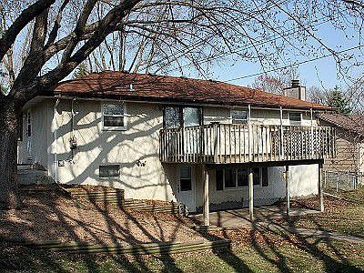 Back view, showing the large 20X12 deck, lower level walkout, and fenced yard.