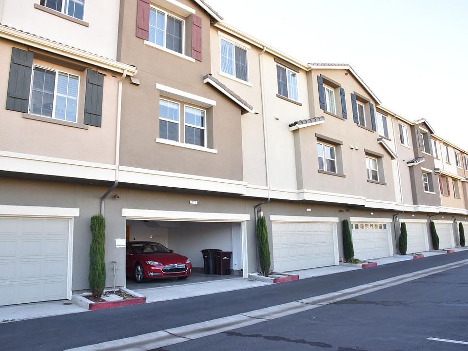 Front view of the townhome, with the garage door open