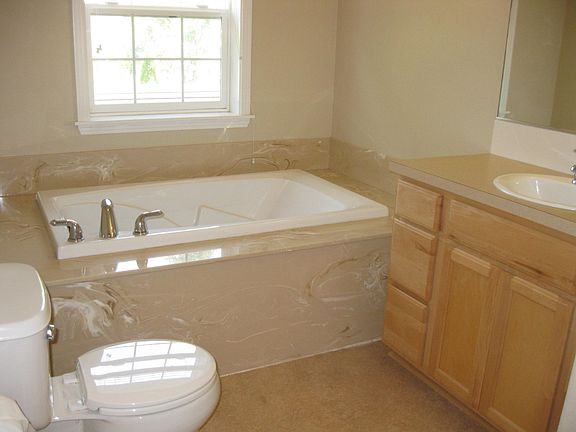 Large soaking tub and bathroom details.