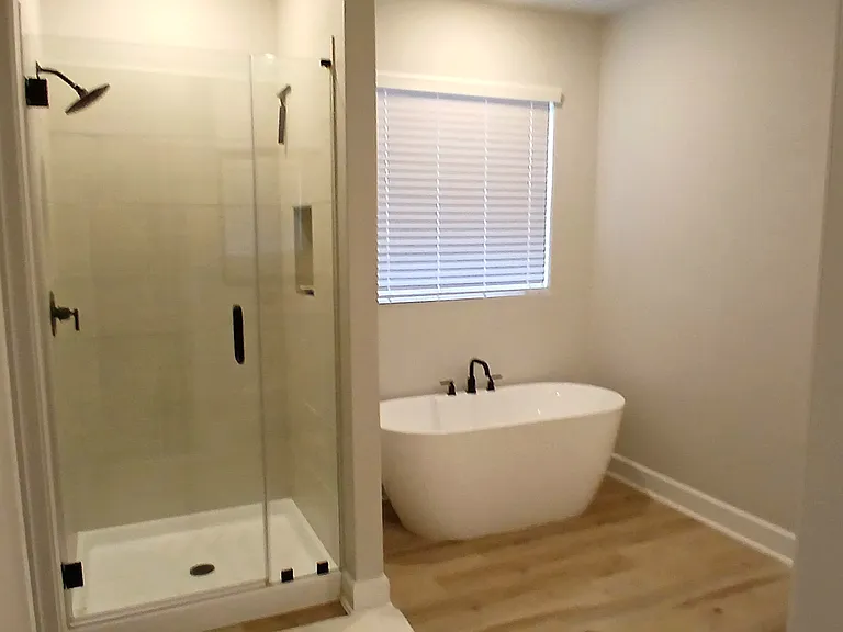 Master bathroom has large tub and walking shower