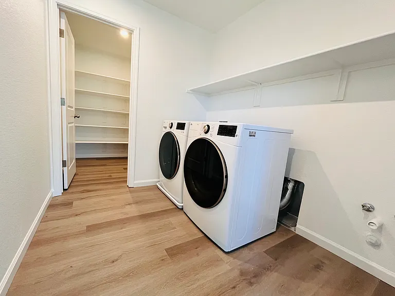 Laundry room w/ washer n dryer and storage