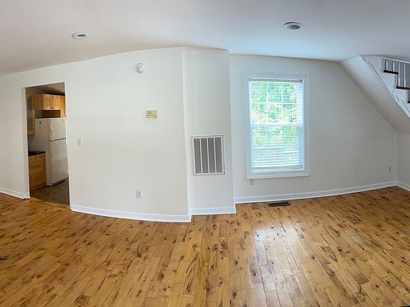 Panorama of living room. This is what you see when entering the front door. The small children's bedroom is on the left, stairs on right and kitchen is straight ahead.