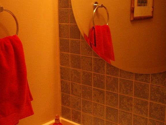 half bath with beautiful tile backsplash