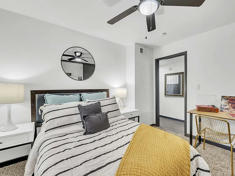 Experience tranquility in this chic bedroom with modern decor and a functional workspace.