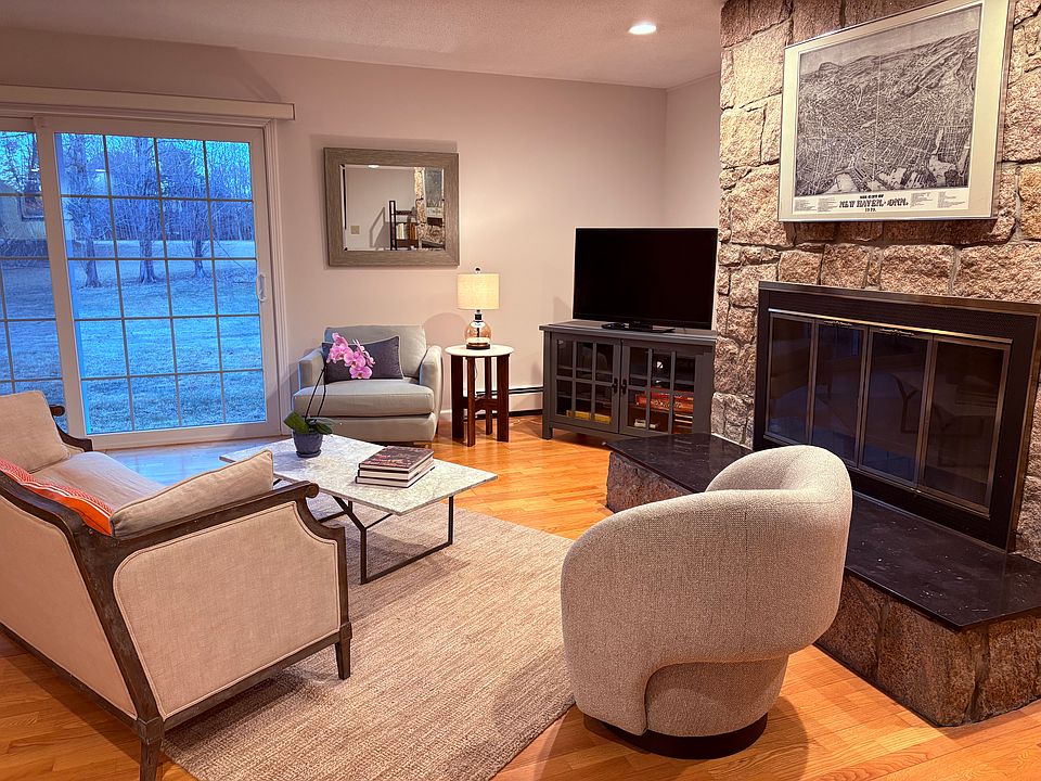 Living room features a Stony Creek granite fireplace, comfortable furniture, TV with Roku, and board games.