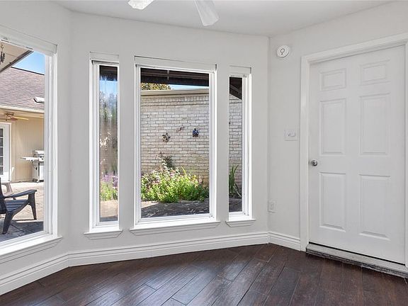 Natural light from the private courtyard floods the breakfast room! This door leads to the utility room, courtyard and garage doors.