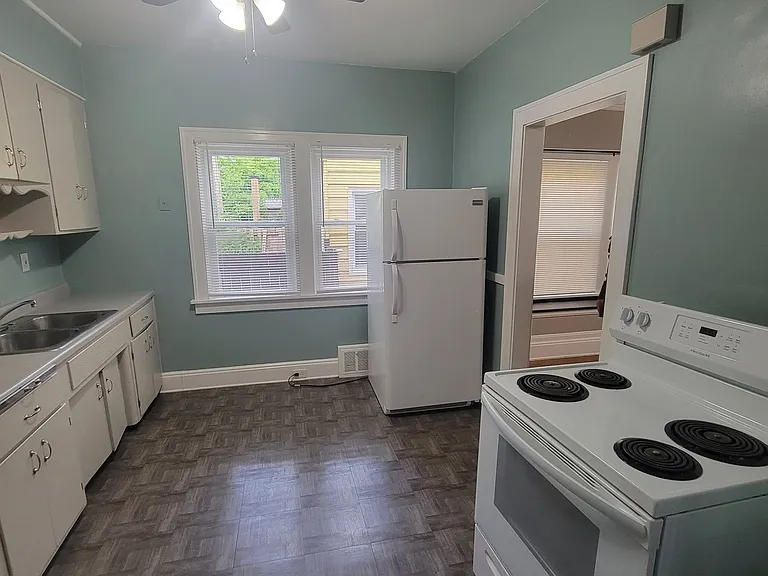 Kitchen with ceiling fan, refrigerator and stove included