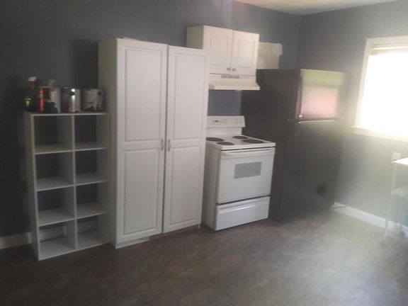 Left side of Kitchen with Stove and Frig and lots of storage