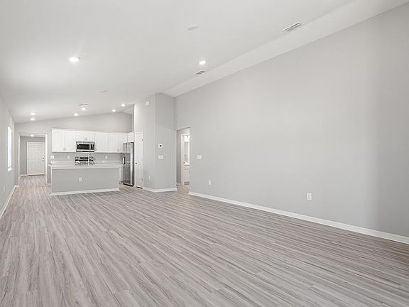 Enjoy a sunny, open-concept living area with volume ceilings - Ashlyn by Highland Homes