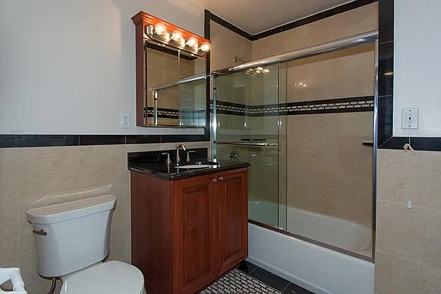 CERAMIC TILE AND MARBLE BATH, FRAMELESS SHOWER DOORS, RAIN SHOWERHEAD, GRANITE VANITYTOP
