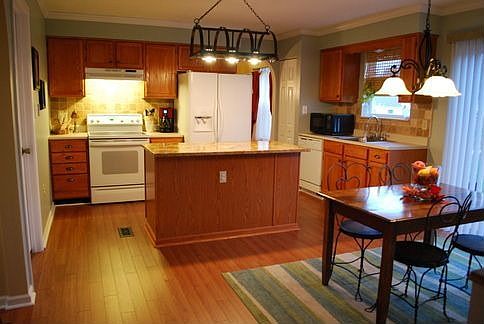 Updated kitchen with granite island and marble backsplash