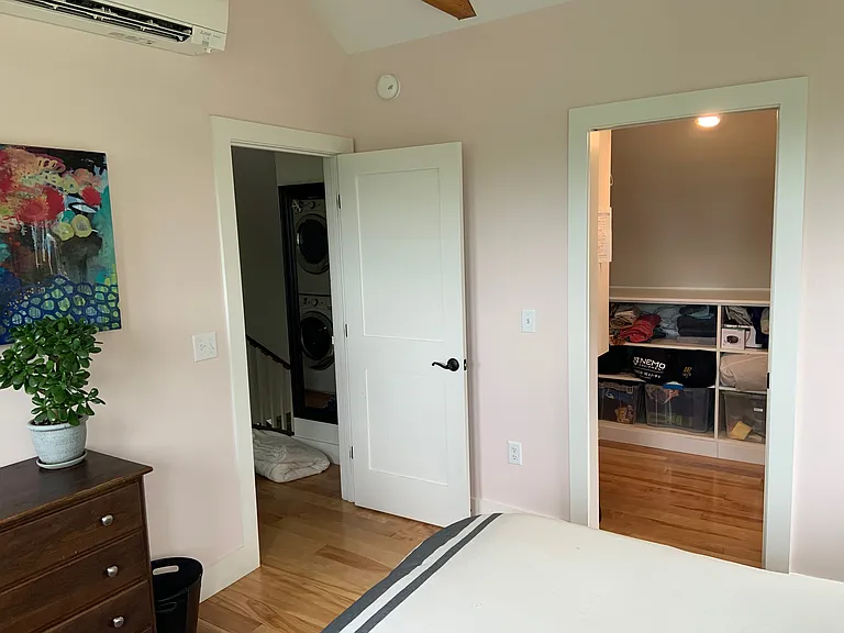 Huge walk-in clothes and storage closet 12ft x 6ft with multiple custom shelves and hanging areas.