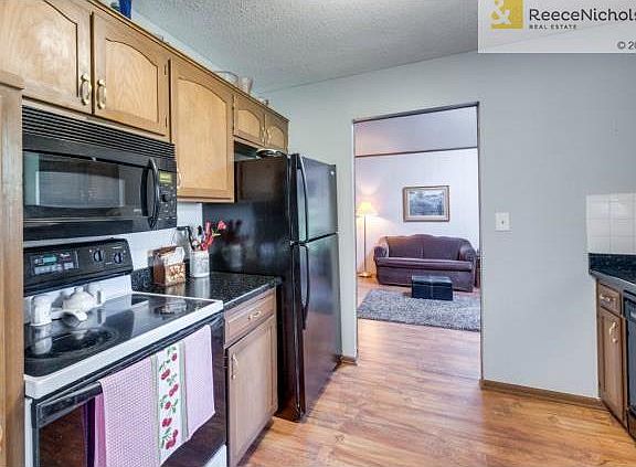 Kitchen features side pantry and opens to family room.