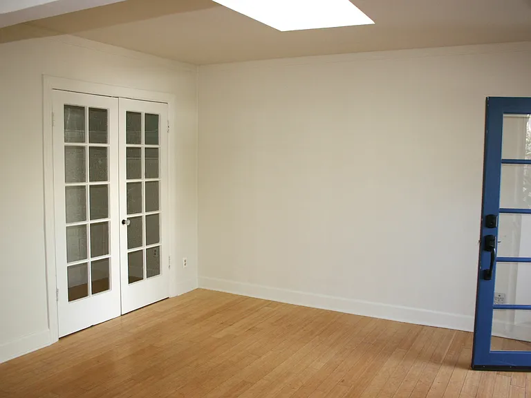 Front room with French doors to large closet / office space - featured sky light overhead