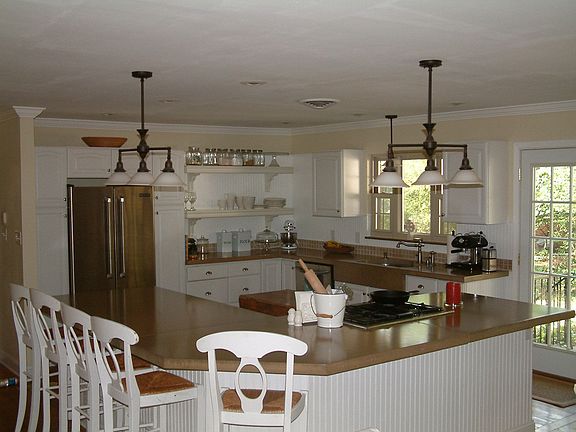 Open kitchen with large island, concrete countertops 