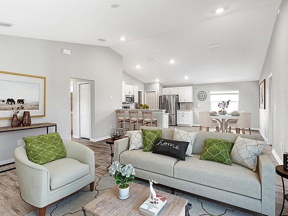 The sunny and open gathering room welcomes you home - Orchid home plan by Highland Homes