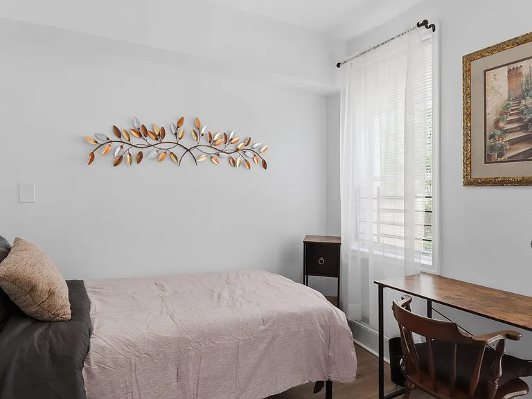 1st floor rear bedroom. With workspace, window, mini fridge, full length mirror and easy outdoor acces