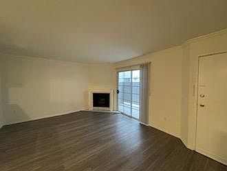 Living room with fireplace and private front patio