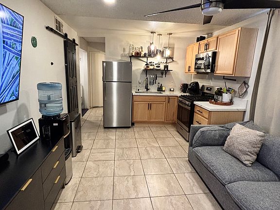 Kitchen/ living room combo. A/C window unit. Ceiling fan. All appliances included. Deep farm style kitchen sink with dish drying rack. Furniture not included.